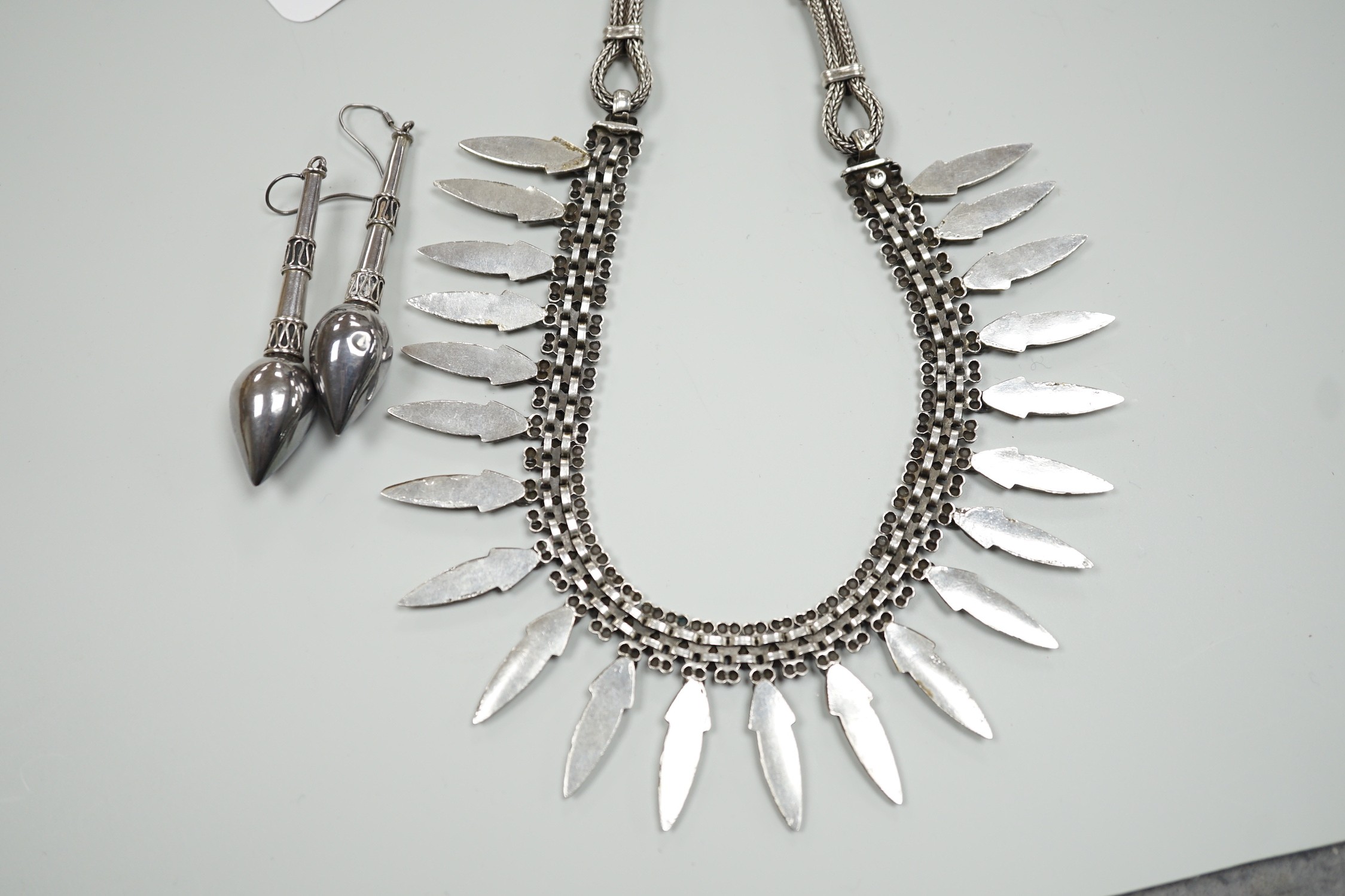 A late 20th century Balinese 925 white metal drop fringe necklace, 43cm, together with a pair of white metal drop earrings, 63mm.